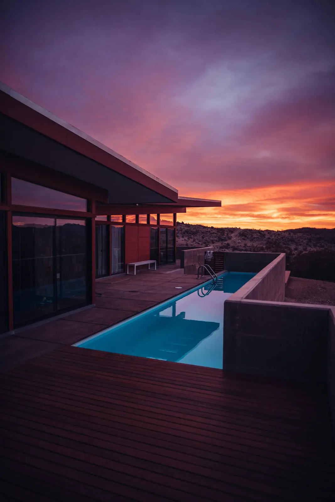 Desert home with a pool at dusk